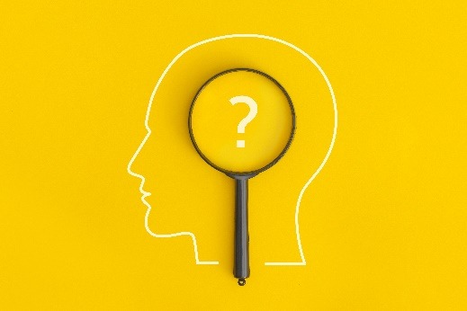 Head outline and magnifying glass